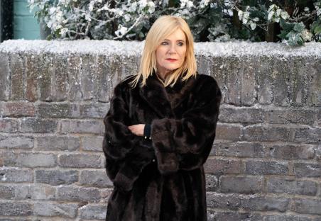 Michelle Collins as Cindy Beale in a brown fur coat.