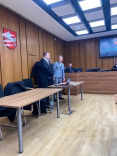 Courtroom scene with defendants and judge.