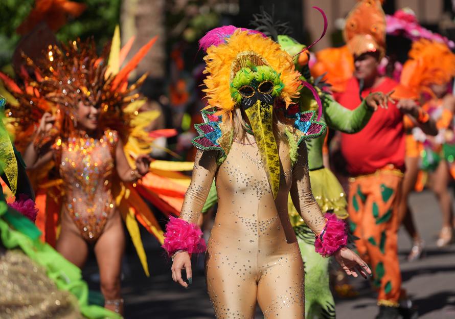 Dancers in colorful costumes at the Notting Hill Carnival.