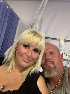 A woman and man in a hospital room.