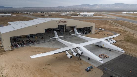 Rear view of the Stratolaunch Roc, a large twin-fuselage aircraft.
