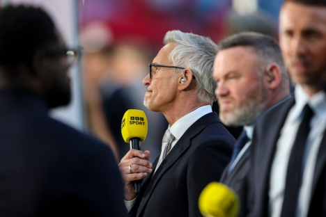 A man holding a BBC Sport microphone.