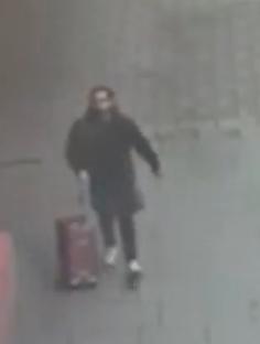 CCTV image of Mourad Aid walking with a suitcase.