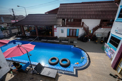 Overhead view of a hotel pool with two inner tubes floating in it.