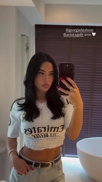 Woman taking a selfie in a bathroom.