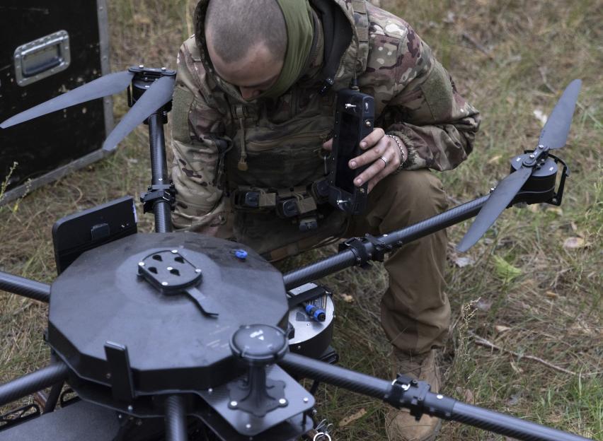 Ukrainian serviceman preparing a Vampire unmanned aerial system for flight.