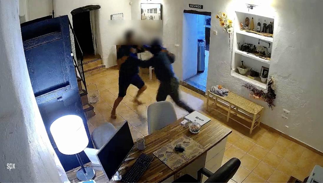 Security camera footage of masked burglars fighting with a homeowner.