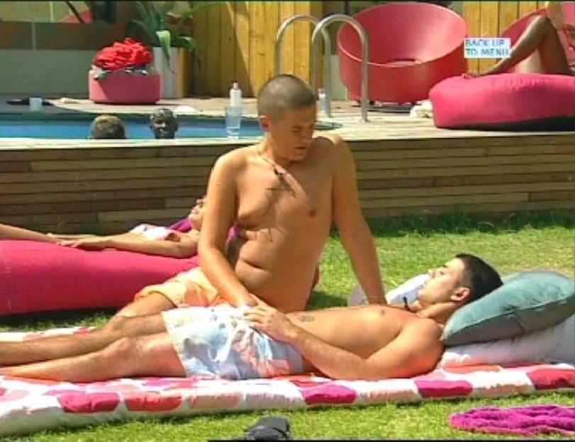 Craig Coates sitting on Anthony Hutton sunbathing by the pool.