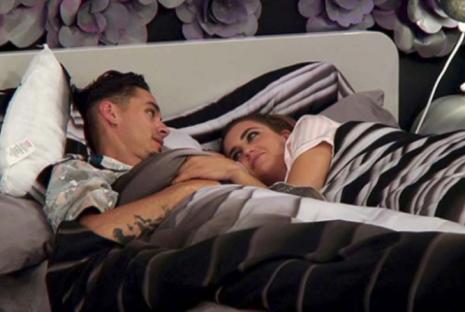 Couple cuddling in bed.