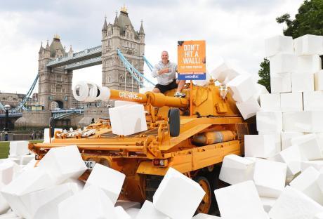 *** FREE FOR EDITORIAL USE *** Grenade stops nation from hitting a wall by literally smashing it down with a 17 tonne tank. It comes as research reveals 72% of Brits hit a wall multiple times a week, losing 37 minutes of productivity each time with Brits wanting more high protein low sugar snacking options to help.
