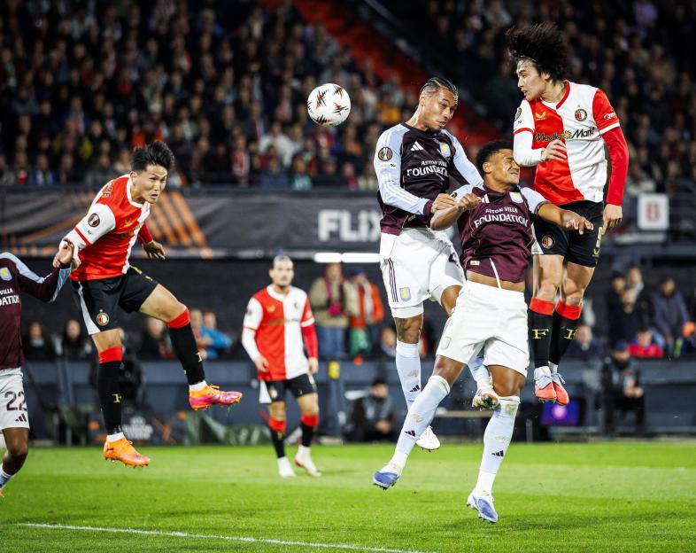 In-beom Hwang, Ezri Konsa, Ollie Watkins, and Ayase Ueda competing for the ball during the UEFA Europa League soccer match between Feyenoord and Aston Villa.