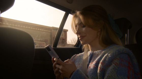 Woman using a phone in a car.