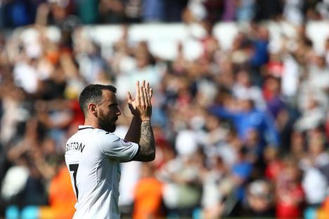 Soccer player Leon Britton applauding fans.