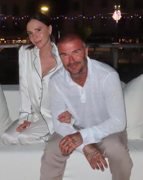 Victoria and David Beckham sitting together.