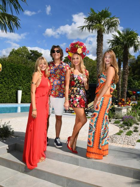 Amanda Holden, husband Chris, and daughters Hollie and Lexi pose outdoors.