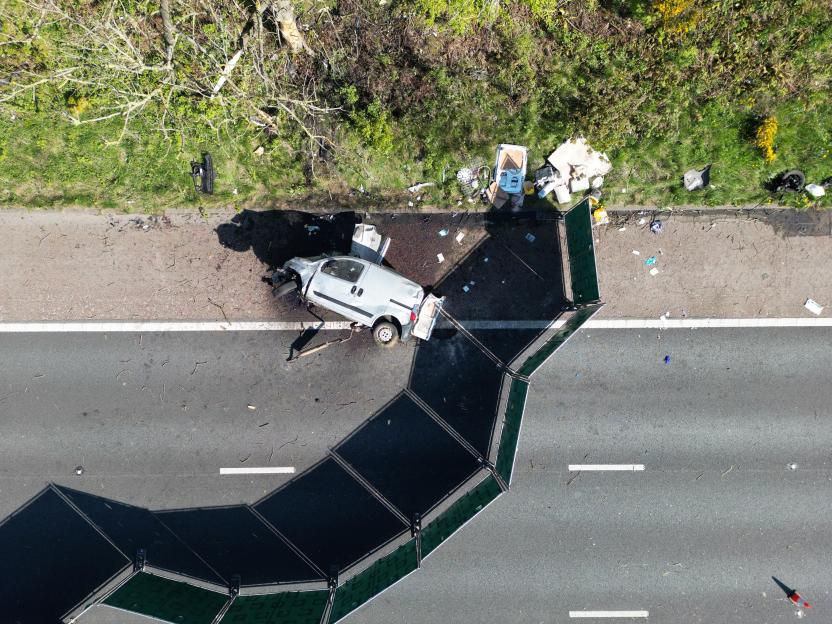 Aerial view of a van crash scene on a highway.