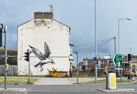 Banksy mural of a seagull on a building wall.