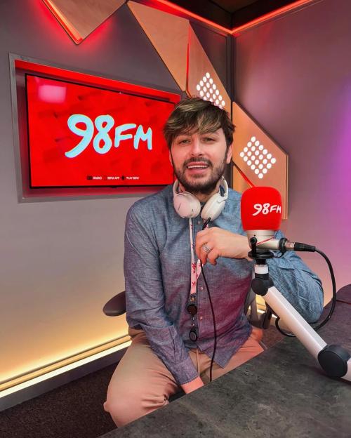 Brian Dowling, a radio DJ, announces his departure from his show while in the 98FM studio.