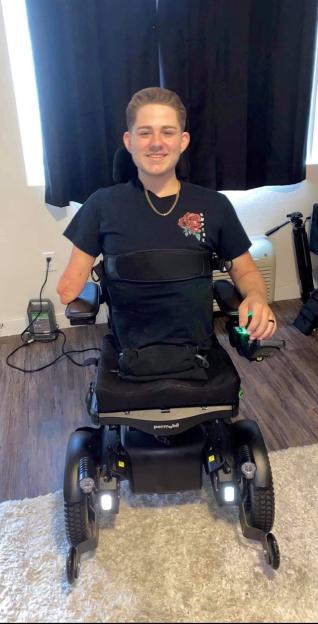 Loren Schauers, a man who survived a horrific forklift accident, sits in his Permobil wheelchair.