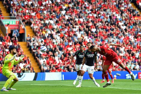 Cody Gakpo heads in a goal during a Liverpool vs Arsenal soccer match.