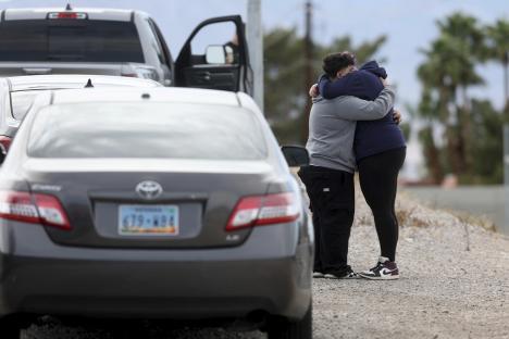 People embracing after an officer-involved shooting.