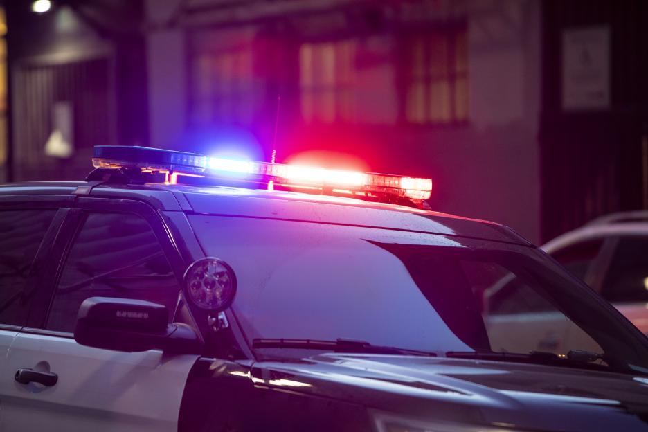 Police car with flashing lights at night.