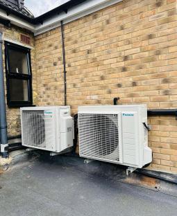 Two Daikin air conditioning units installed on a flat roof.
