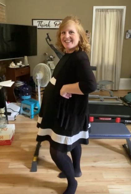 A pregnant woman in a black and white dress.