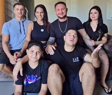 Photo of two couples and their two children posing together.