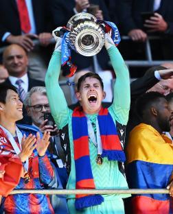 Dean Henderson of Crystal Palace lifts the FA Cup trophy.