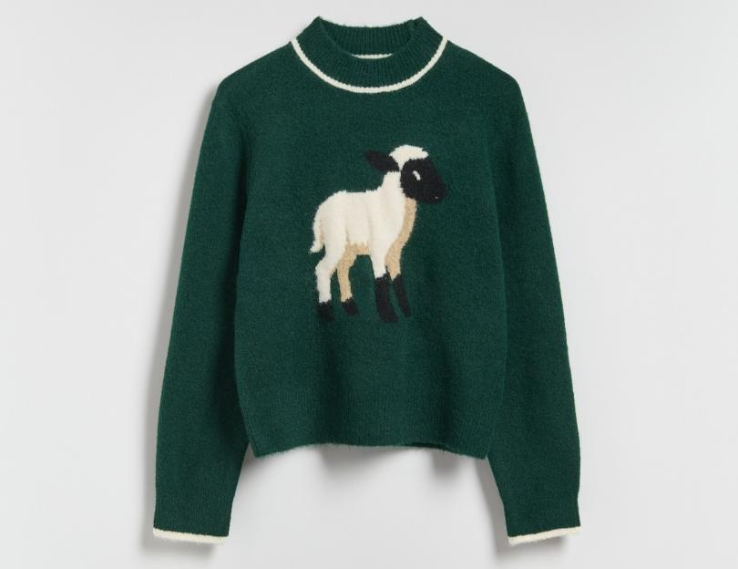 Green sweater with a white and black lamb design.