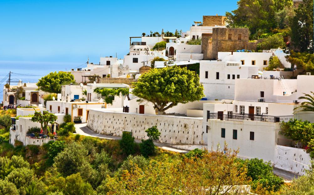 Lindos village with white houses on a hill, overlooking the sea.