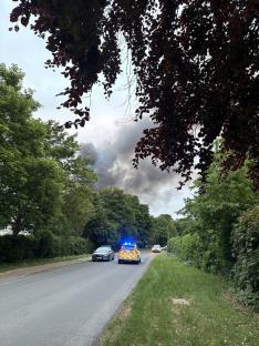 Police car near a large fire.