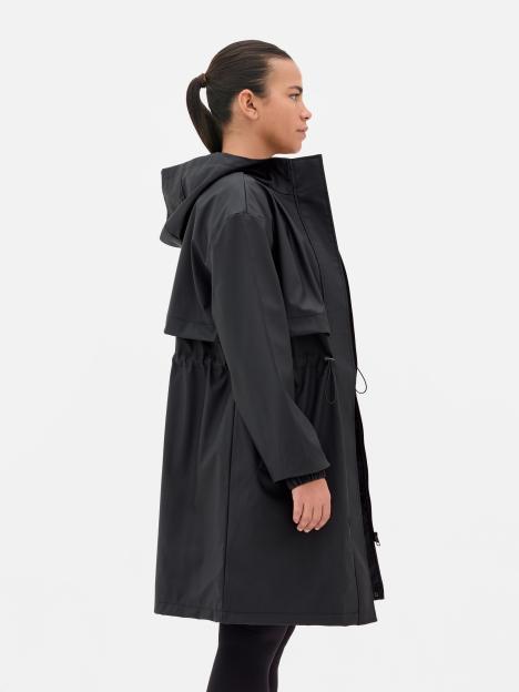 Woman wearing a black hooded raincoat.