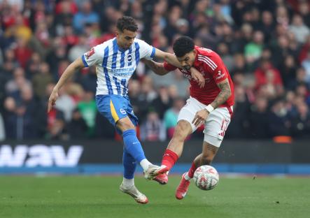 Brighton & Hove Albion's Yasin Ayari and Nottingham Forest's Morgan Gibbs-White vying for the ball during a soccer match.