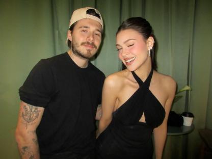 Brooklyn Peltz Beckham and a man posing together.