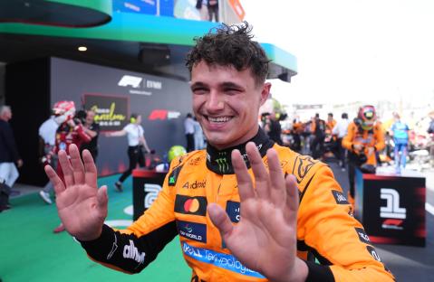 Lando Norris waving after finishing second in a race.