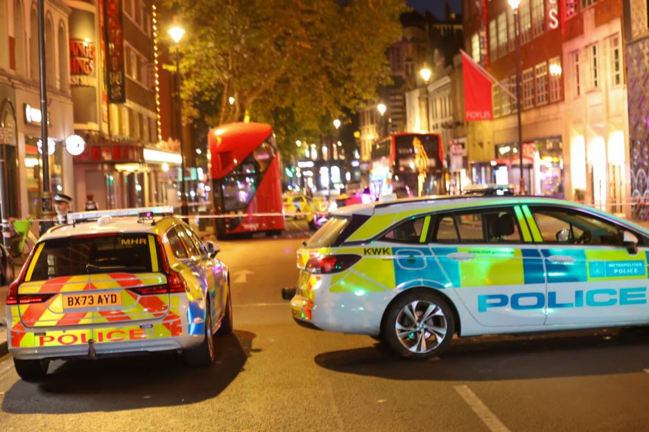Police cars at a night-time accident scene.
