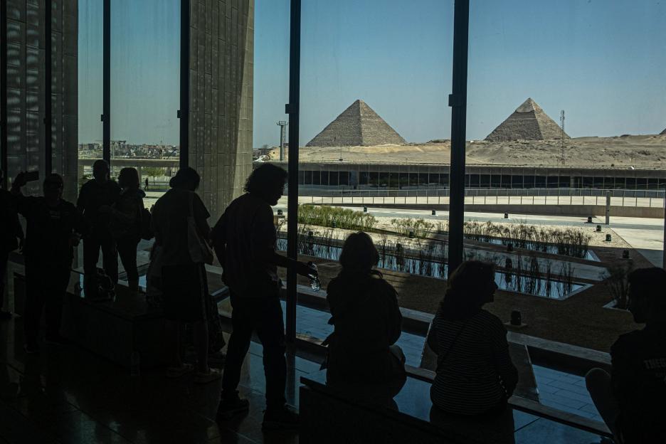 Visitors view the Giza pyramid complex from the Grand Egyptian Museum in Cairo.