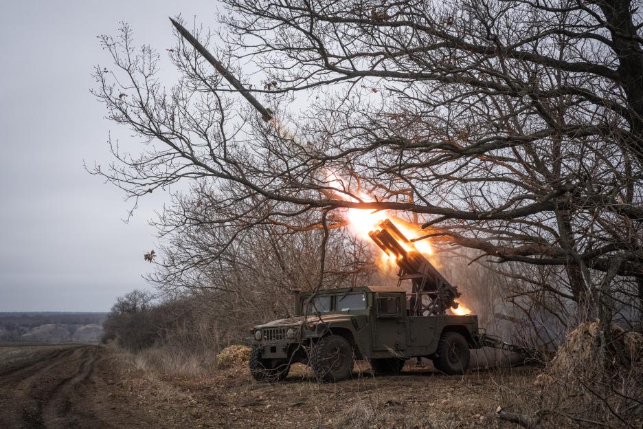 Ukrainian soldiers firing a Soviet-era Grad launcher mounted on an American Humvee.