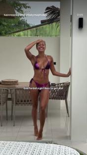 Kaz Crossley in a purple bikini in the rain.