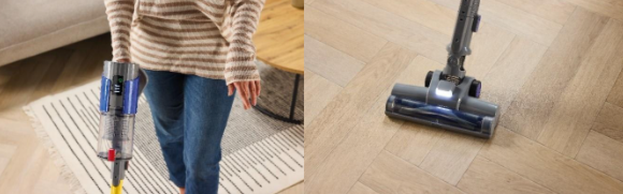 Person using a stick vacuum cleaner on hardwood floor.