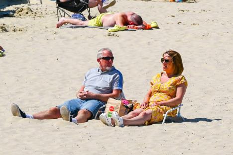 Couple relaxing on a sunny beach.