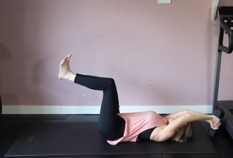 Woman performing a full-body workout exercise.
