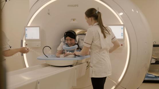 a woman sits in a philips mri machine