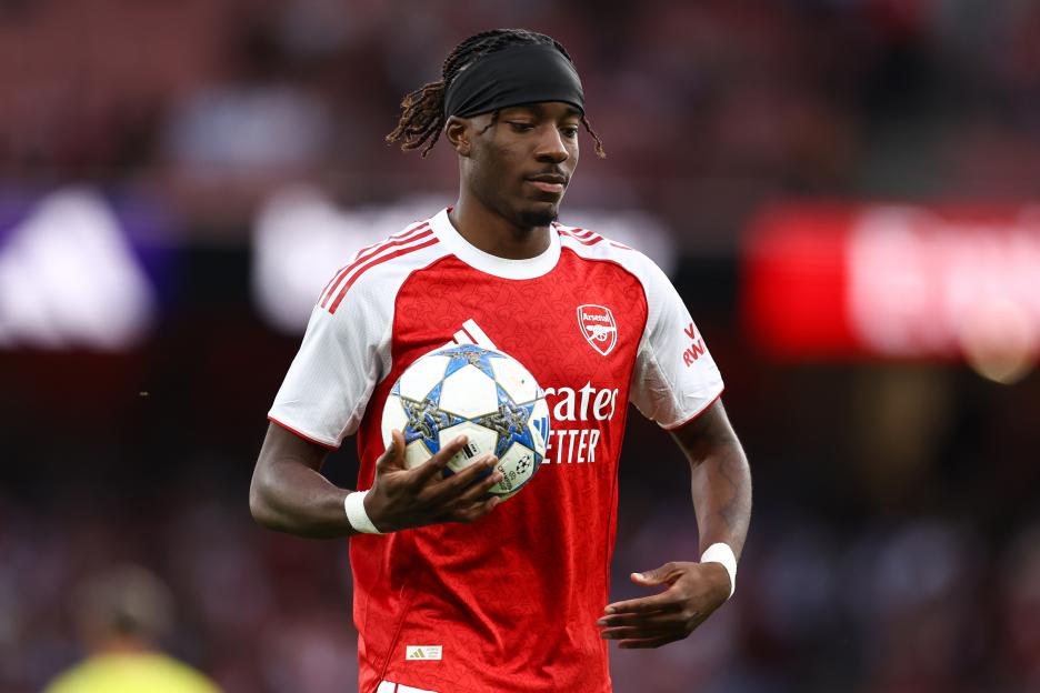 Noni Madueke of Arsenal holding a soccer ball.