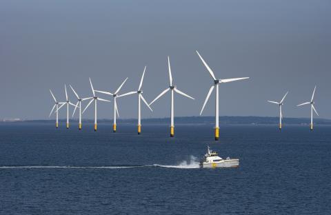 Offshore wind farm with a supply vessel.