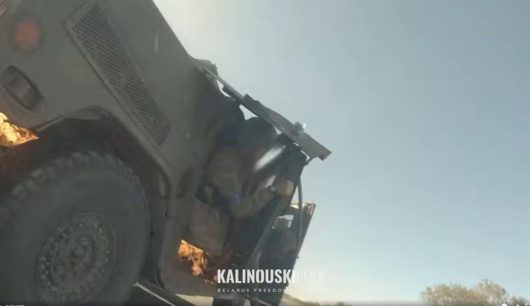 A military vehicle, possibly a Humvee, on fire with "KALINOUSKIEU BELARUS FREEDOM" text overlay.