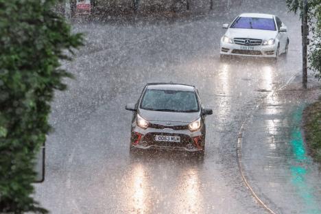 Cars driving through heavy rain.