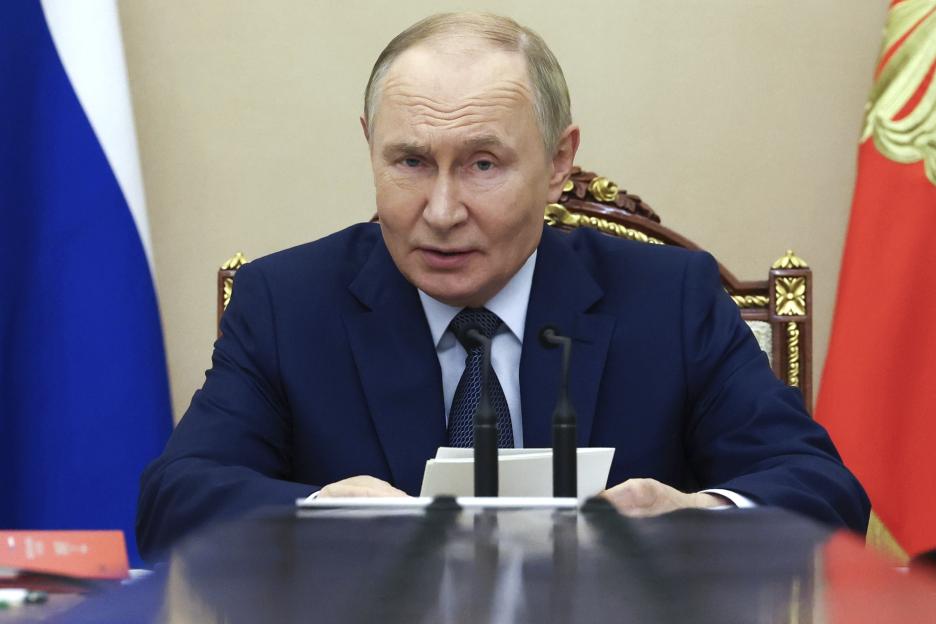 Russian President Vladimir Putin in a navy suit, speaking at a Security Council meeting.